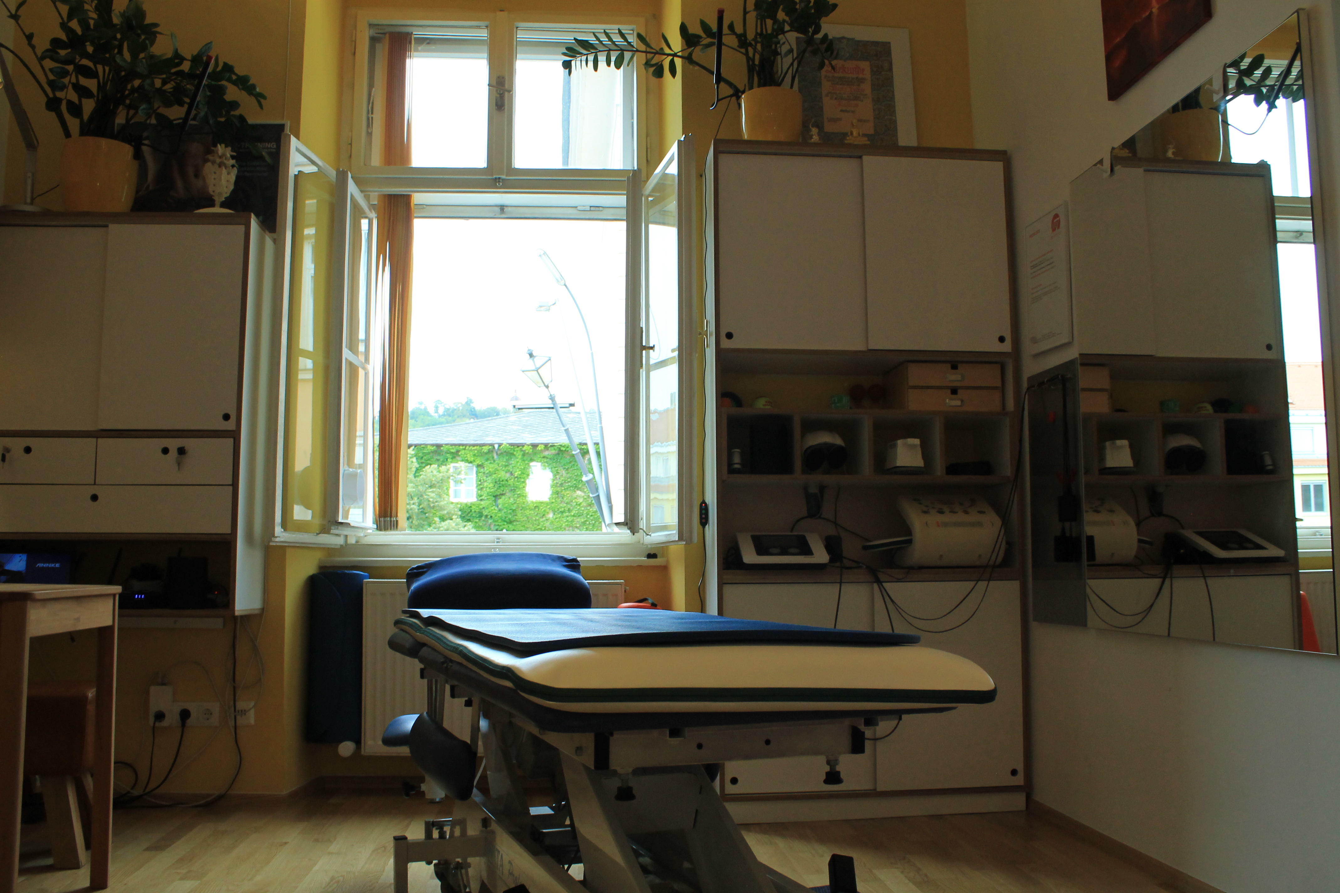Behandlungsraum bei MP7 Wellness in Graz mit Massageliege am Fenster